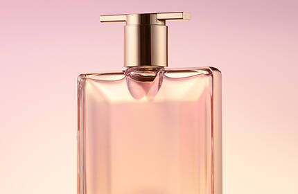 A bottle of perfume labeled "Midnight Rose" with a rose detail, set against a soft purple backdrop.